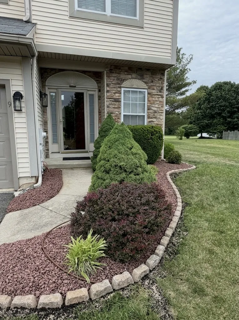 Completed stone edging around a front garden bed
